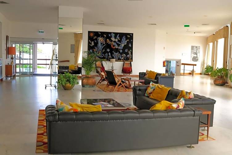 A room with a couch and a chair

Description automatically generated